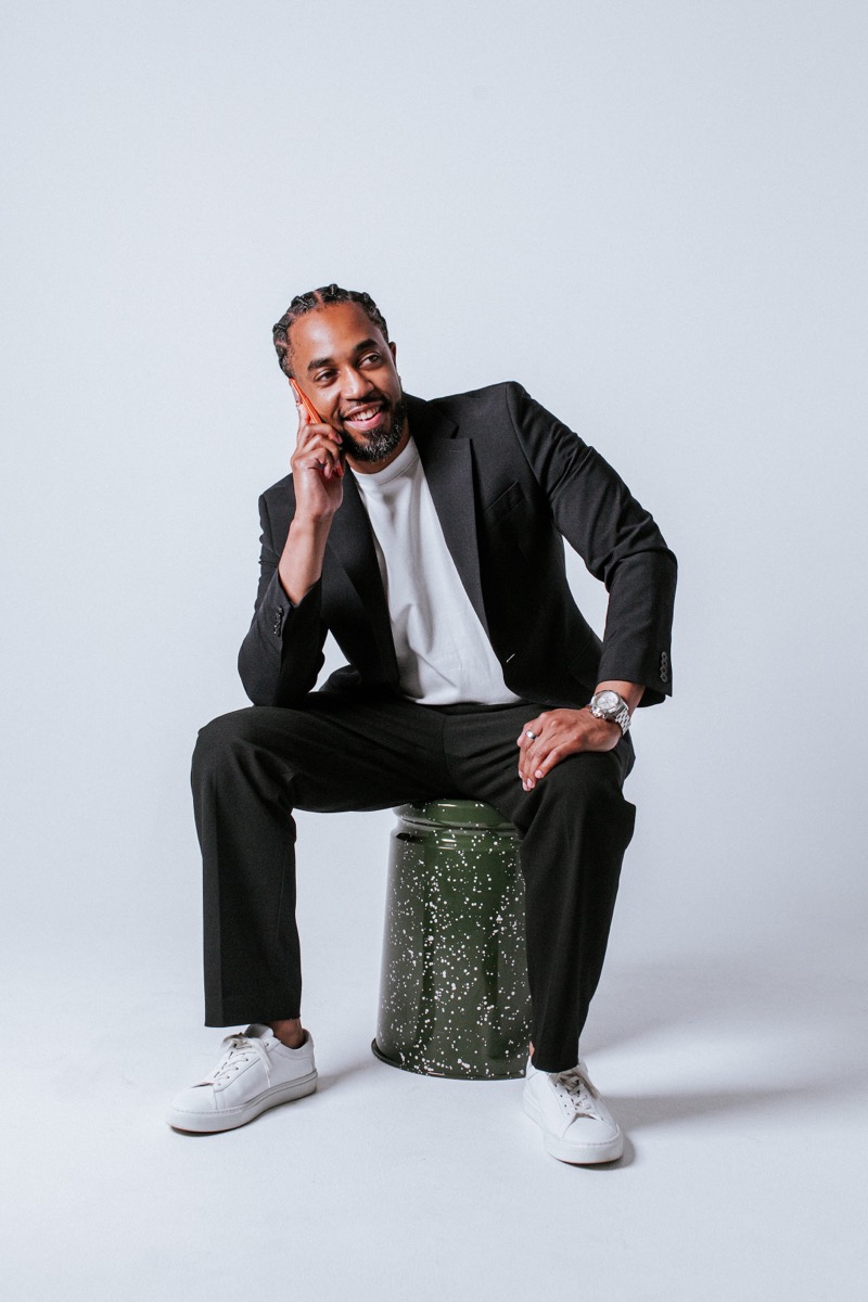 Cliff Worley seated on a stool, smiling