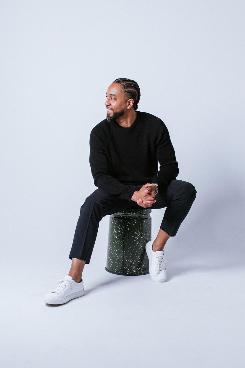 Cliff Worley seated on a stool in a black sweater