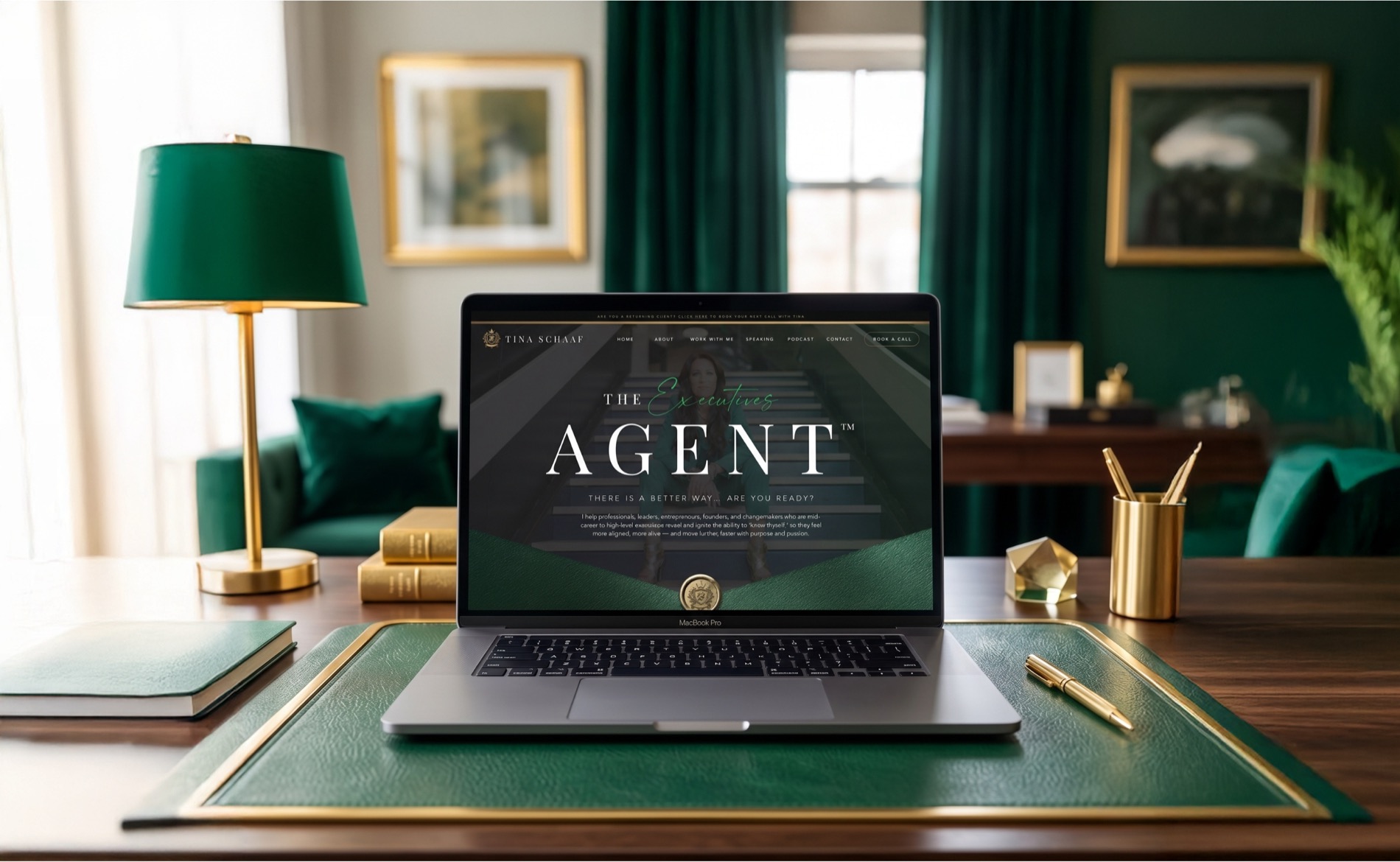 Tina Schaaf’s The Executives Agent website on a laptop in an emerald and gold office